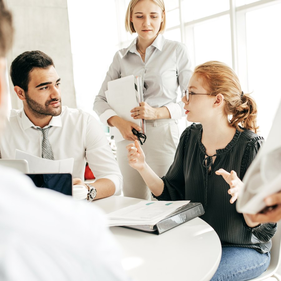 A team discussing documents around a table
